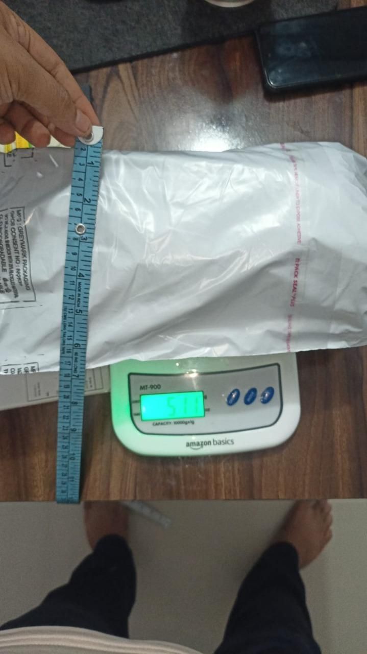 Package on a digital scale with a ruler for measurement